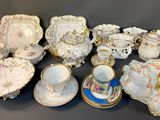 many different types of porcelain dishes and cups on the table