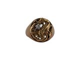a close up of a gold ring with a diamond in the center