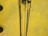 two fishing poles and a hat on a yellow wall