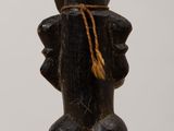 wooden figurine of a man with a hat and a hat on his head