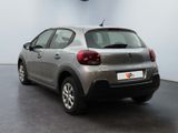 the back of a silver citrole parked in a room