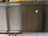 a large stainless steel oven in the middle of a kitchen