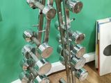 a metal rack with a lot of pots and pans on it