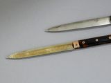 two knives that are sitting next to each other on a table