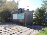 a small wooden building with a sign on it