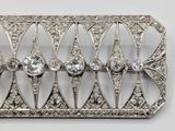 an image of a silver broochle with diamonds on a white background