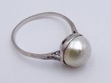 sterling silver ring with a white pearl on a white background