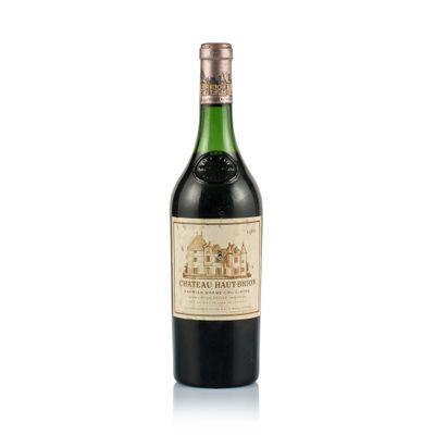 a bottle of wine sitting on top of a table next to a white background