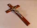 une croix en bois surmontée d'un crucifix, posée sur une table
