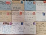 several old envelopes are stacked on top of each other on a table