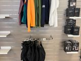 a rack of clothes on a wall in a store