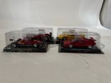 two red toy cars are in a clear case on a white surface