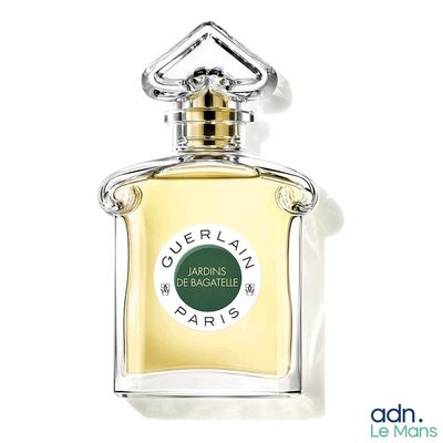 the bottle of perfume is sitting on a white surface
