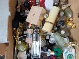 a cardboard box full of bottles and other items