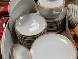 a lot of plates and bowls on the table