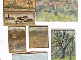 many paintings on display on the wall of this room