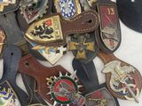 a lot of different types of badges on a table
