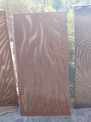 three pieces of wood are sitting next to each other on a cement surface