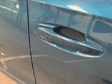 a close up of a car door handle with a sticker on it