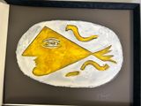 a picture of a yellow and white plate with a face on it