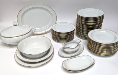 a lot of white and gold plates and bowls on the table