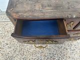 a small wooden table with a blue drawer underneath it