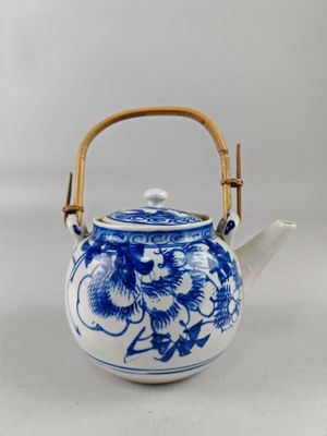 blue and white porcelain teapot with bamboo handle