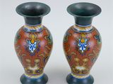 two vases that are sitting on a table