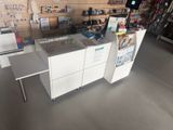 an image of a store with a counter and a printer