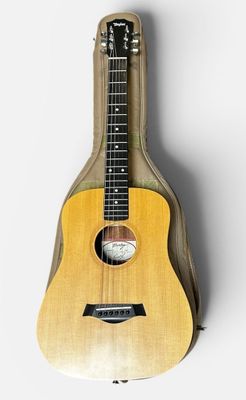 a close up of a wooden guitar on a white background