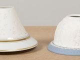 two white and blue vases sitting on a table