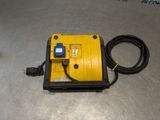 an electric device with a cord connected to it on a metal surface