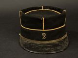 an old black hat with the number 2 on it on a black background