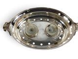 a silver plate with two candles inside of it