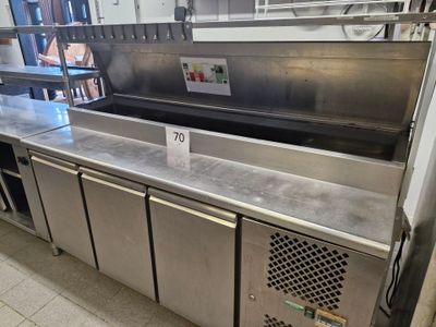 a stainless steel kitchen with a sink and a counter top