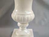 a white vase that is sitting on a table