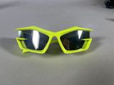 a close up of a pair of yellow sunglasses on a table