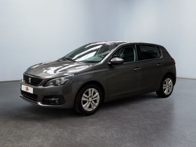 the grey car is parked in a large room with a black floor