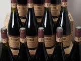 many bottles of wine sitting in a wooden crate