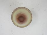 a glass with a brown substance on it sitting on a table