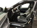 the interior of a car with the door open and the driver ' s seat down