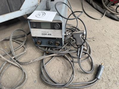 a machine that is sitting on the ground next to some wires