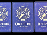 three blue playing cards with one piece and one piece on them