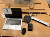 a laptop, mouse, cell phone, and other electronic devices on a table
