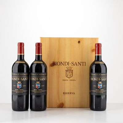 three bottles of red wine in front of a wooden box