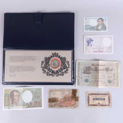 several different types of currency are laid out on a white surface