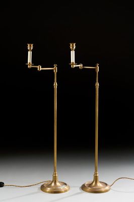 a pair of brass plated floor lamps