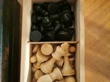 a box with chess pieces and a book on the table