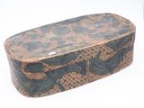 a brown and black snake skin box on a white surface