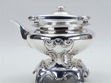 silver plated teapot on stand with handle and lid